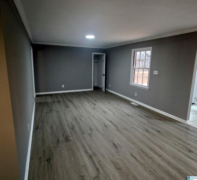 spare room with crown molding and light hardwood / wood-style floors