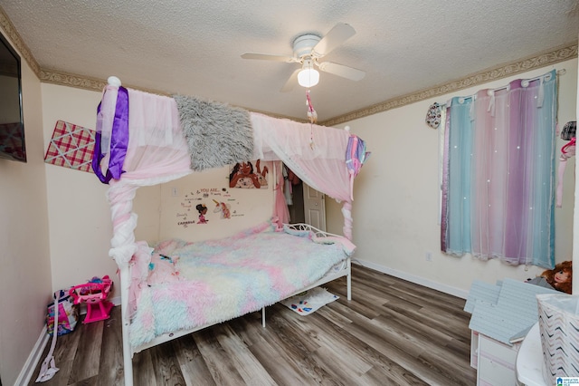 bedroom with ceiling fan, hardwood / wood-style floors, and a textured ceiling