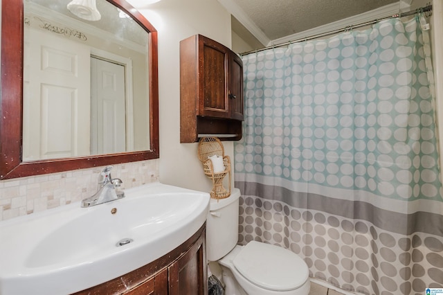 bathroom with backsplash, ornamental molding, vanity, toilet, and a textured ceiling