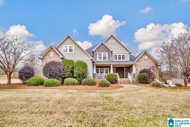 craftsman-style house with covered porch and a front lawn