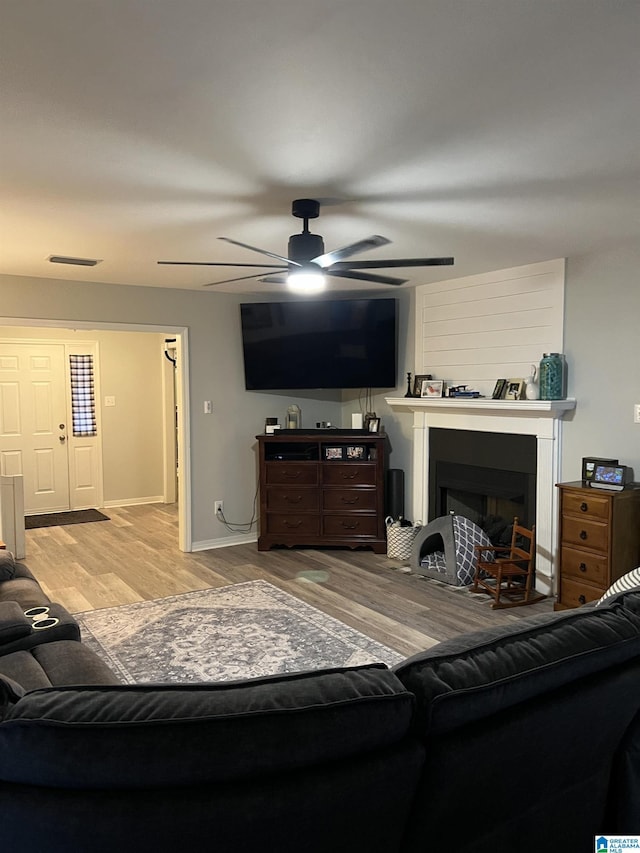 living room featuring ceiling fan and light wood-type flooring