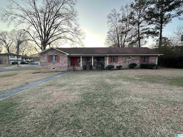 ranch-style home featuring a front yard and a porch