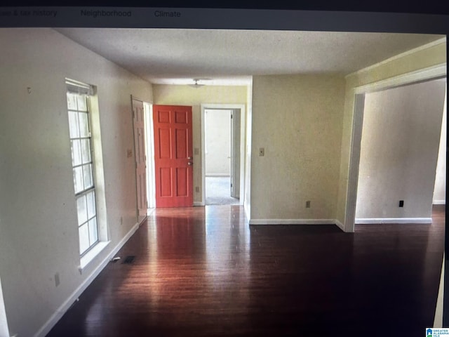 empty room featuring dark hardwood / wood-style flooring