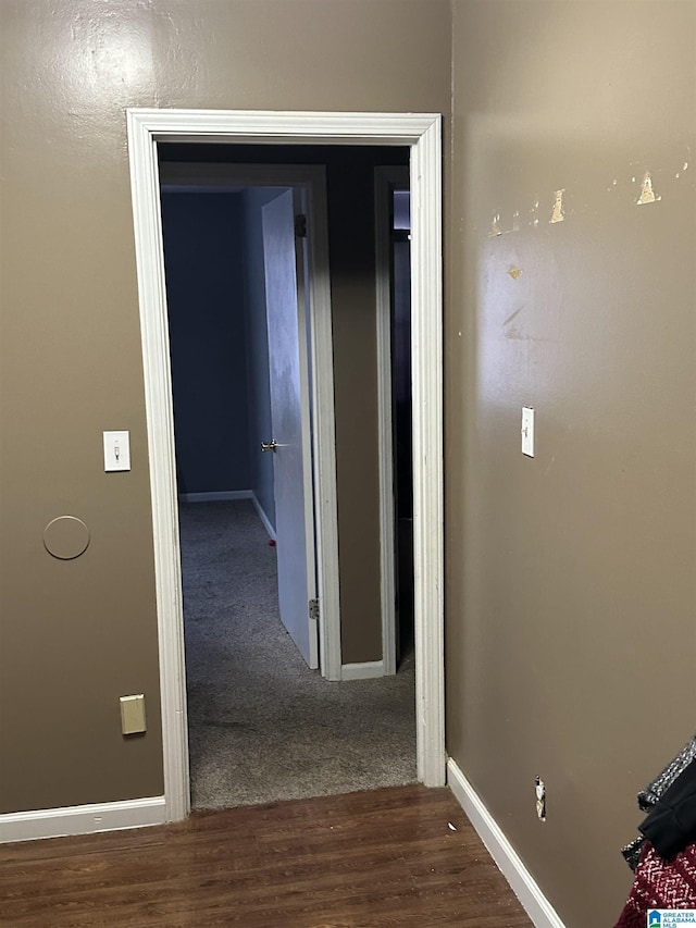 hall with dark wood-type flooring