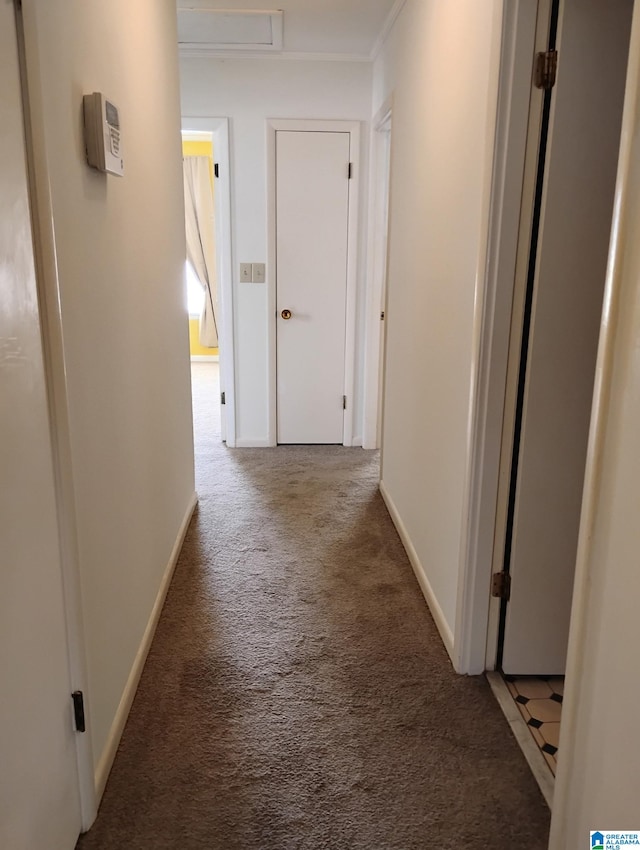 corridor featuring carpet and baseboards