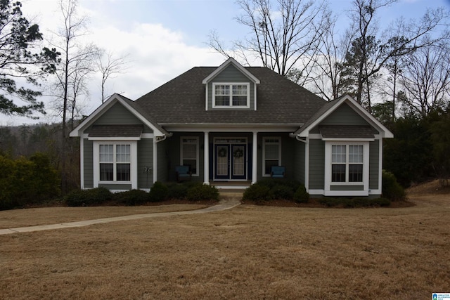 view of front of home with covered porch and a front yard