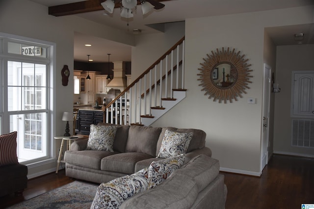 living area with baseboards, visible vents, dark wood finished floors, ceiling fan, and stairs