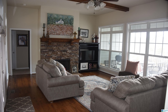 living room with dark wood-style floors, beam ceiling, a fireplace, and ceiling fan