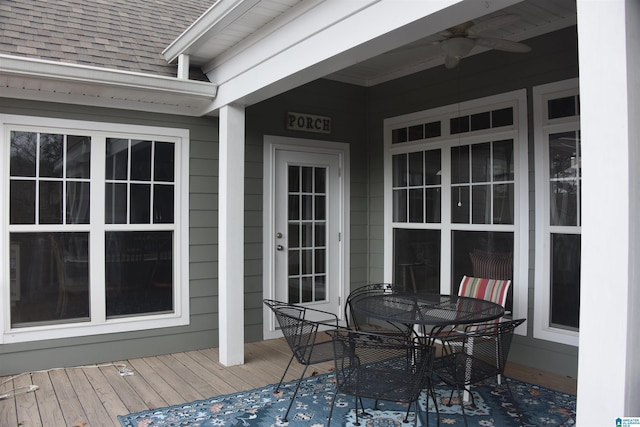 wooden terrace featuring outdoor dining space and ceiling fan