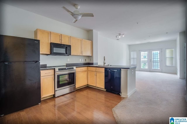 kitchen featuring sink, black appliances, french doors, kitchen peninsula, and light brown cabinets