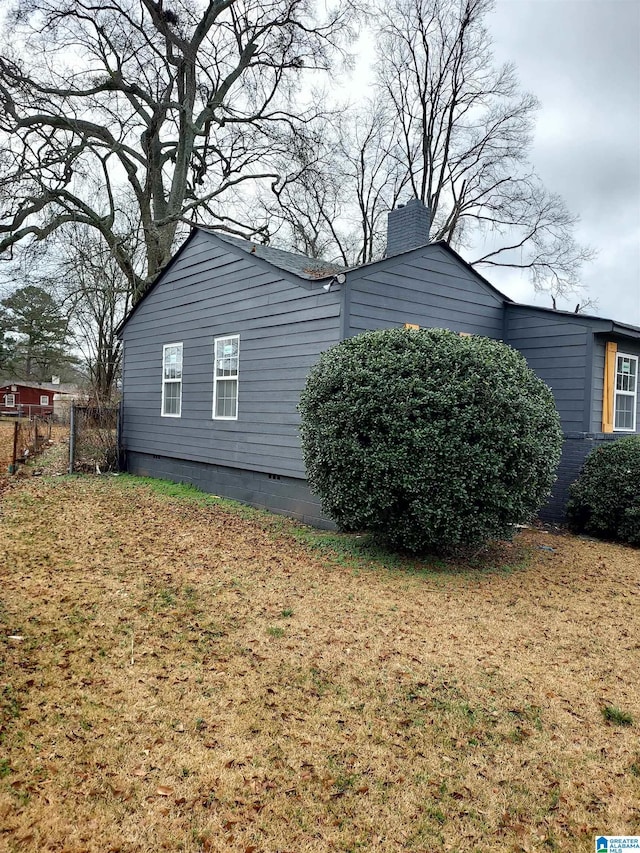 view of property exterior with a lawn