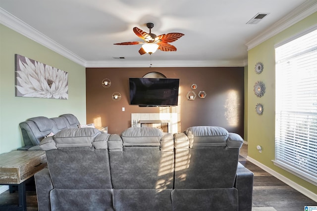 living room with crown molding, dark hardwood / wood-style floors, and a wealth of natural light