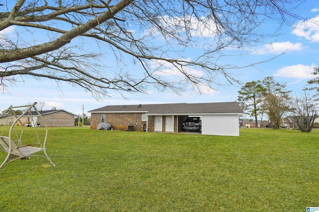 rear view of house with a lawn