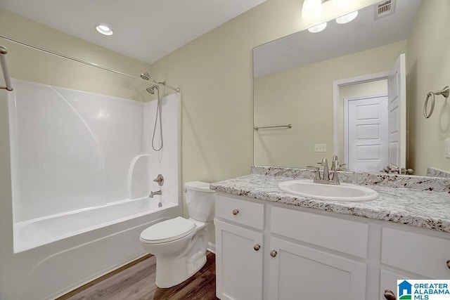 full bathroom with vanity, toilet, bathing tub / shower combination, and hardwood / wood-style floors