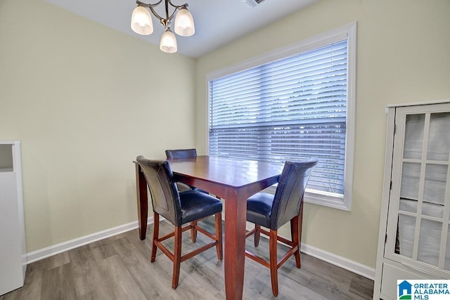 dining area featuring a chandelier and light hardwood / wood-style flooring