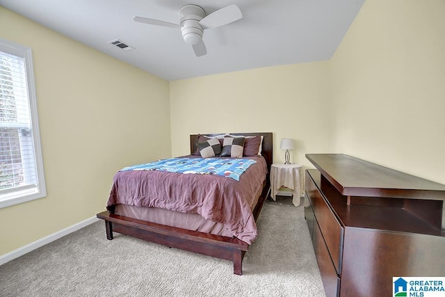 bedroom featuring light carpet and ceiling fan