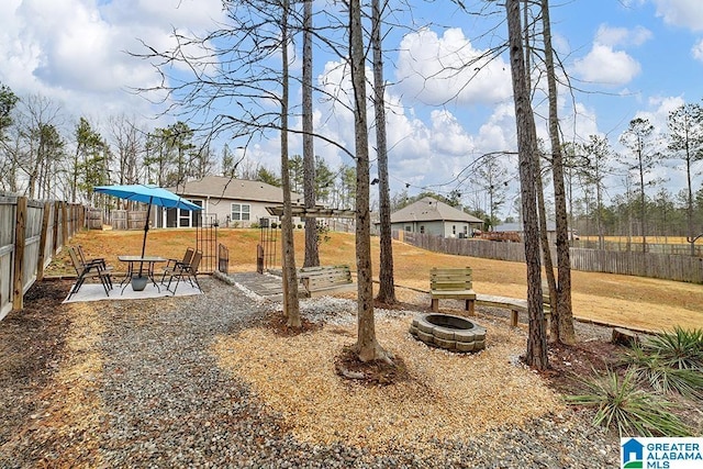 view of yard with an outdoor fire pit and a patio area