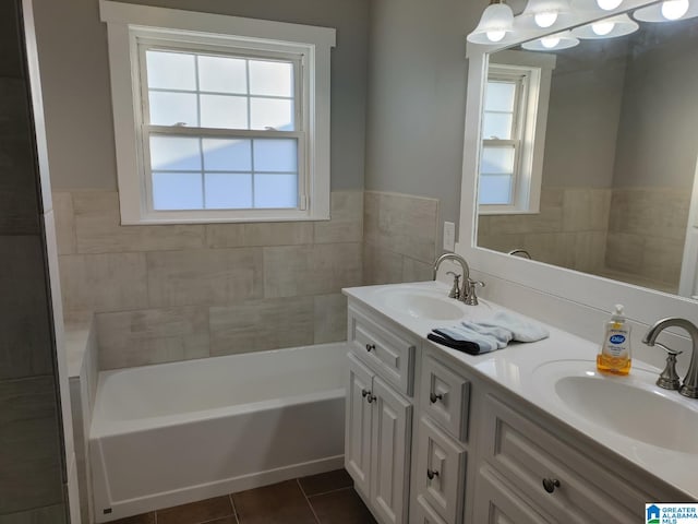 bathroom with vanity, plenty of natural light, tile patterned floors, and a tub to relax in