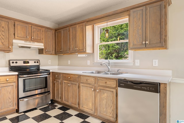 kitchen with sink, a textured ceiling, and appliances with stainless steel finishes