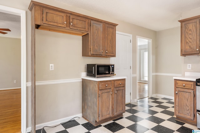 kitchen with a textured ceiling and ceiling fan