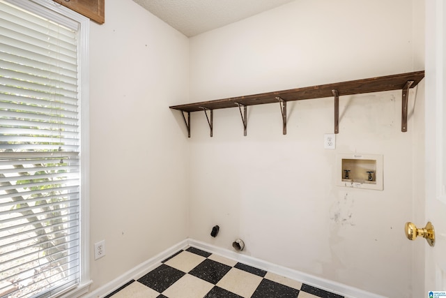 laundry room with washer hookup, hookup for a gas dryer, a wealth of natural light, and a textured ceiling