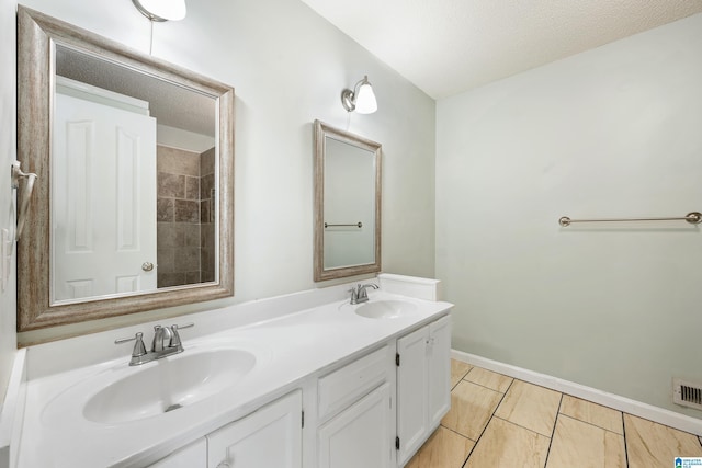 bathroom with vanity and a textured ceiling