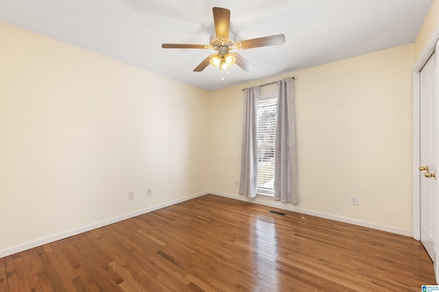 spare room with wood-type flooring and ceiling fan