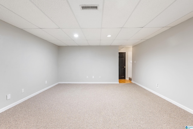 carpeted spare room with a paneled ceiling