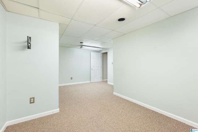 unfurnished room with carpet floors and a paneled ceiling