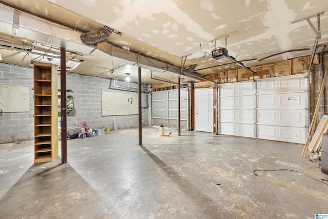 garage with a garage door opener and electric panel