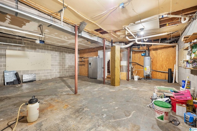 basement with water heater and stainless steel fridge