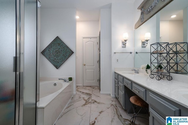 bathroom with vanity and a tub