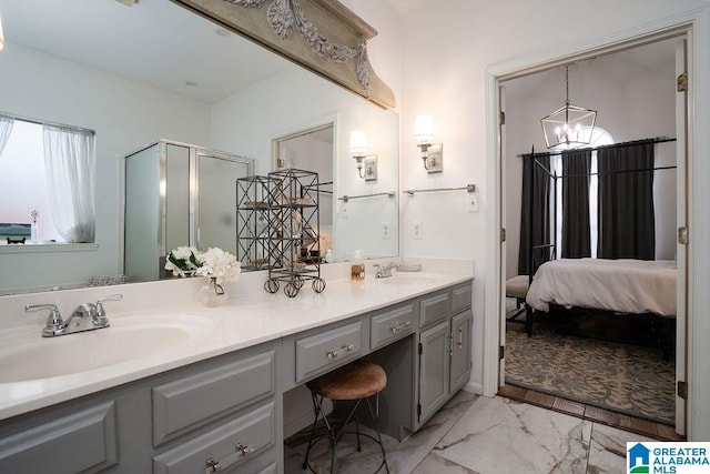 bathroom with an inviting chandelier, vanity, and walk in shower