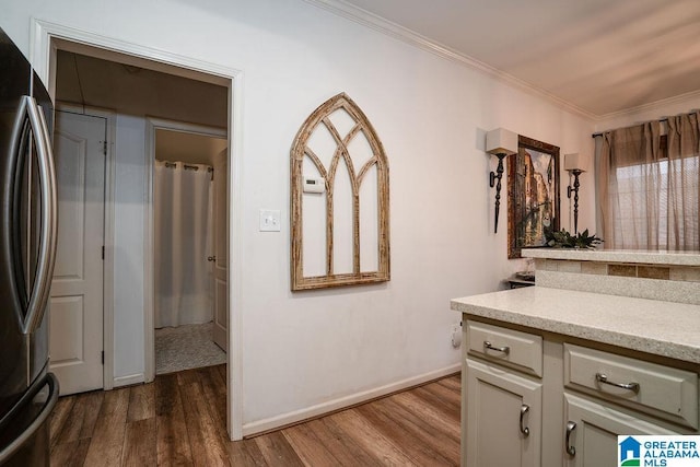 interior space with ornamental molding, hardwood / wood-style floors, and vanity