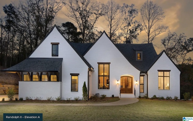 modern farmhouse style home featuring a lawn