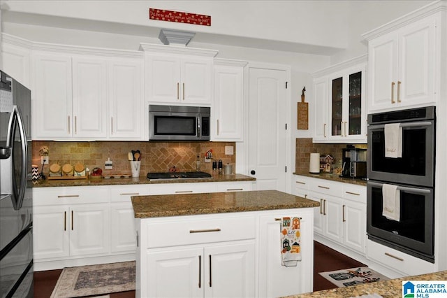 kitchen featuring white cabinetry, a kitchen island, and appliances with stainless steel finishes