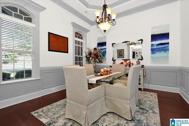 dining space featuring dark hardwood / wood-style flooring, crown molding, a tray ceiling, and an inviting chandelier