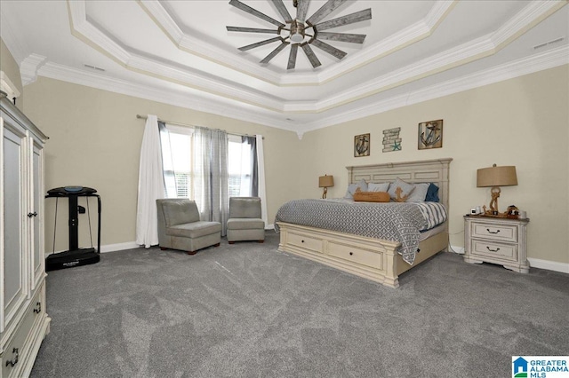 carpeted bedroom with crown molding and a tray ceiling