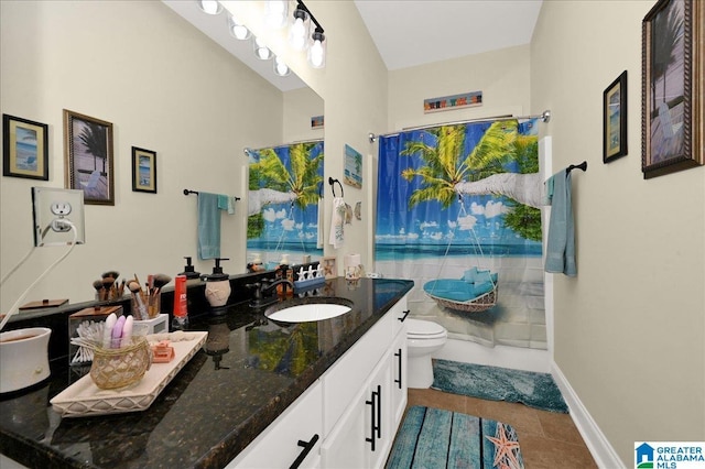 bathroom with a shower with curtain, vanity, toilet, and tile patterned flooring