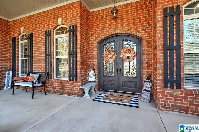 property entrance featuring french doors and a porch