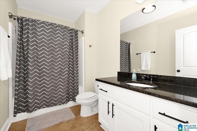 bathroom with tile patterned flooring, vanity, and toilet