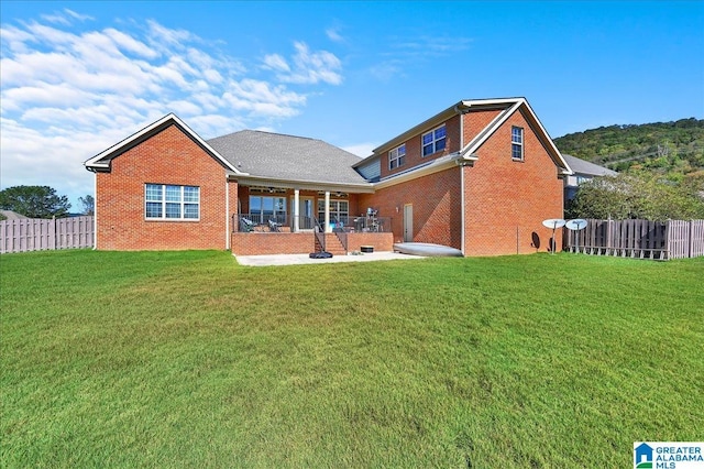 back of property featuring a yard and a patio