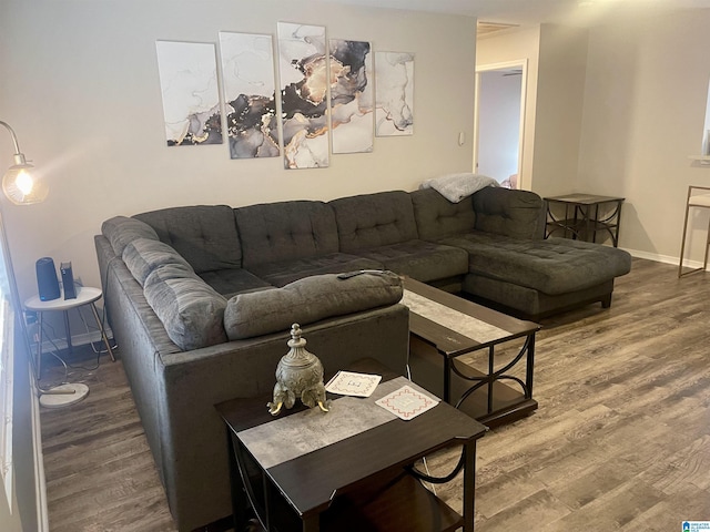 living room with baseboards and wood finished floors