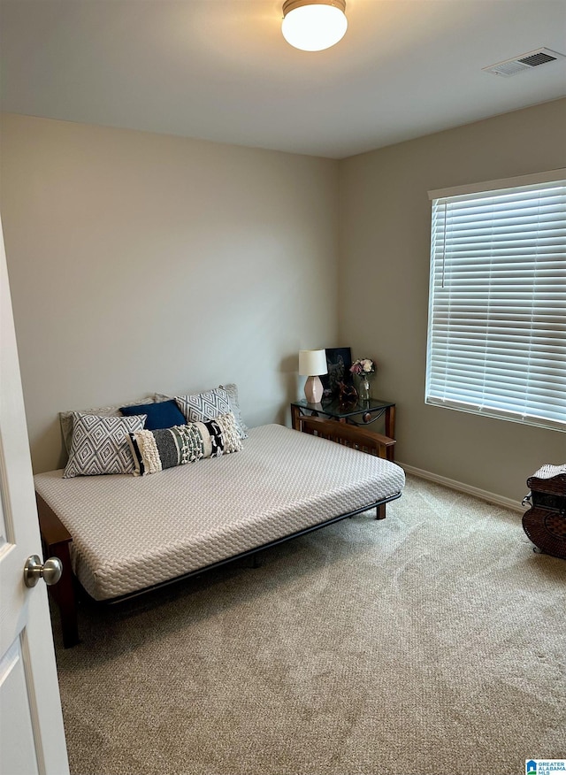 bedroom featuring carpet, visible vents, and baseboards