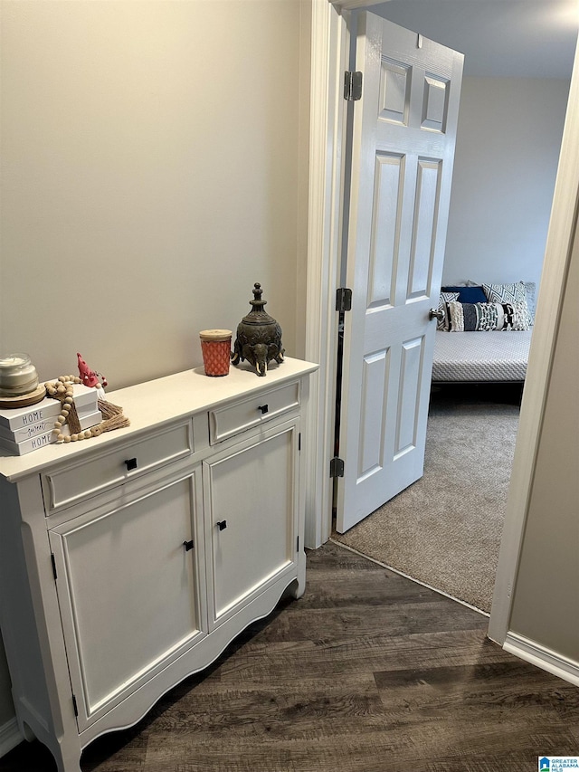 corridor featuring dark wood-style flooring