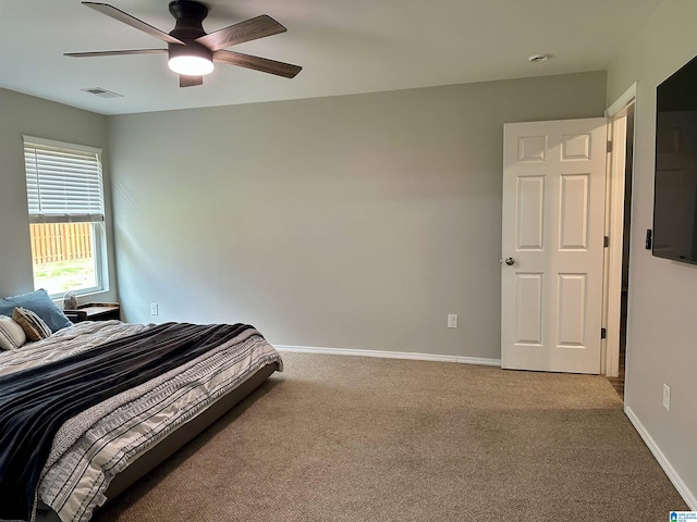 bedroom with a ceiling fan, baseboards, visible vents, and carpet flooring