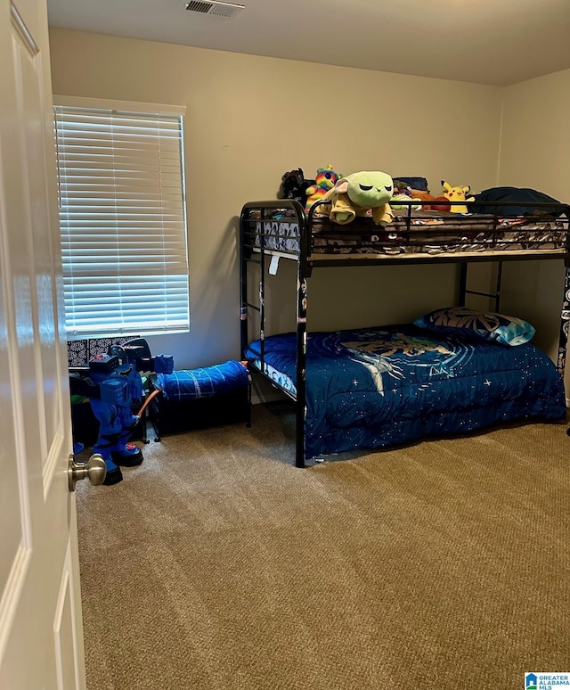 carpeted bedroom with visible vents