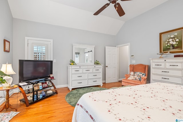 bedroom featuring lofted ceiling, ceiling fan, and light wood-type flooring