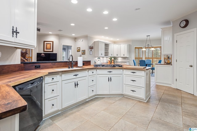 kitchen with wood counters, sink, decorative light fixtures, and black dishwasher