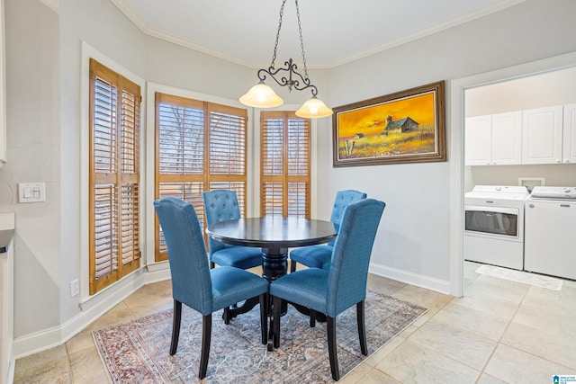 dining space with crown molding and washer and clothes dryer